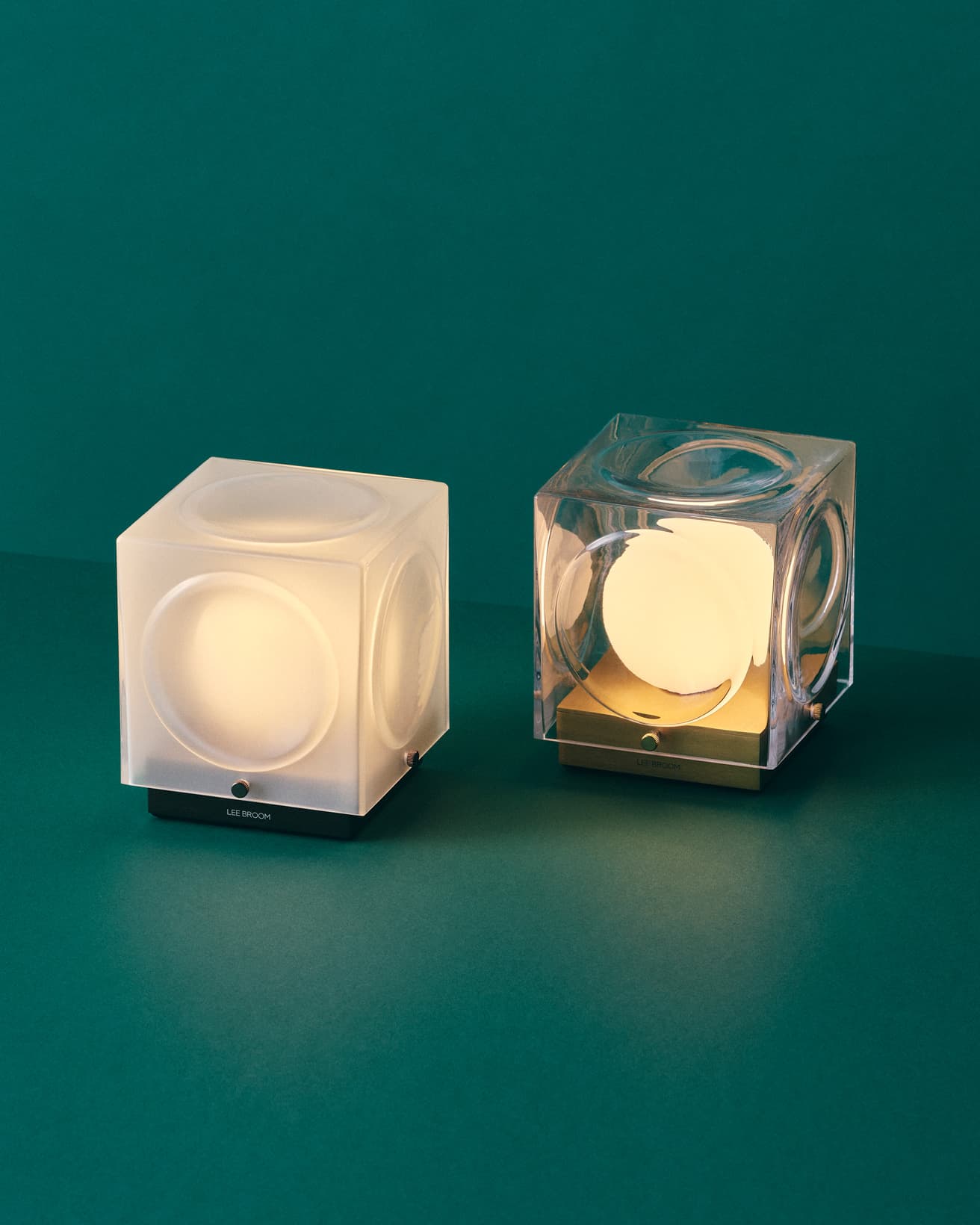 《チャント ポータブルランプ》ガラスシェードはクリアとフロストの2種。ベースカラーは、ブロンズ、ゴールド、シルバーの3色から。写真は、フロスト&ブロンズとクリア&ゴールド。調光は4段階。W12.6×D12.6× H14.3cm。83,600円。●リー・ブルーム TEL 03 5778 3283。